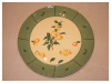 A Bali stoneware cheeseboard plate, decorated with apples and leaves and green border - third pot view.