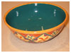 A Bali stoneware wide bowl, decorated with geometric design diamonds and triangle shapes in vibrant colour glazes - third view.