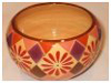 A Bali stoneware round shape bowl, decorated with geometric design with diamond shaps and daisies in autumn colours - second view.