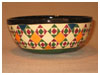 A Bali stoneware wide low bowl, decorated with geometric design diamonds and triangle shapes in vibrant colour glazes - second view.