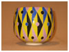 A Bali stoneware geometric design pot, decorated in triagles and circles using vibrant colour glazes - first view.