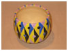 A Bali stoneware geometric design pot, decorated in triagles and circles using vibrant colour glazes - third view.