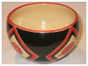 A Bali stoneware round bowl, decorated with poppies in geomatric shapes on black background - second view.