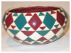A Bali stoneware pot, decoorated with triangle and diamond shapes in geomatric style design - third view.
