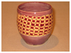 A Bali stoneware vase, decorated with a wickers basket style geometric design - first view.