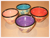 A Bali stoneware set of 4 bowls decorated in different colours with little flowers - third view.
