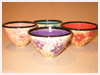 A Bali stoneware set of 4 bowls decorated in different colours with little flowers - first view.