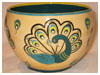 A Bali stoneware bowl, decorated with 4 colourful peacocks on cream background - first view.