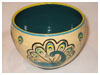 A Bali stoneware bowl, decorated with 4 colourful peacocks on cream background - second view.