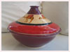 A Bali stoneware moroccan style casserole pot, decorated with camels on red and maroon background - first view.