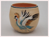 A Bali stoneware bowl, decorated with African crane and dolphines in water on cream background - first view.