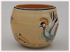 A Bali stoneware bowl, decorated with African crane and dolphines in water on cream background - second view.