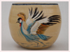 A Bali stoneware bowl, decorated with African crane and dolphines in water on cream background - third view.
